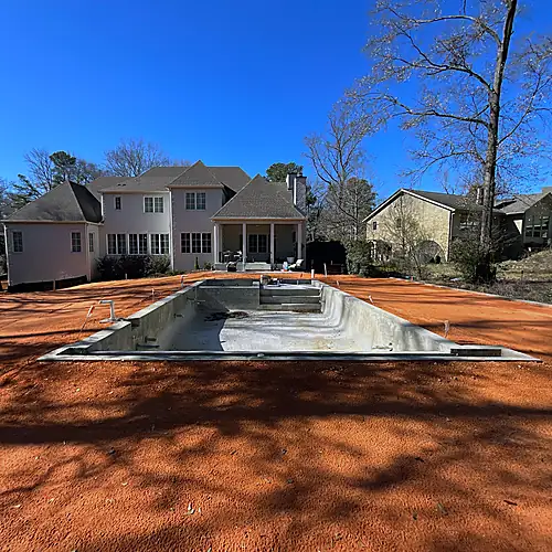Pool shell and exposed soil during backyard construction