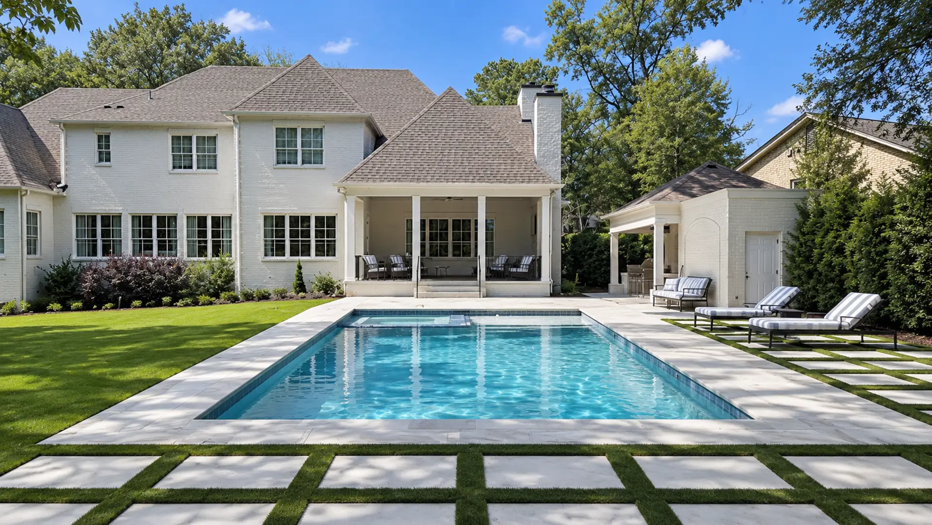 Completed Northport backyard with a pool, limestone paving, lawn and outdoor kitchen
