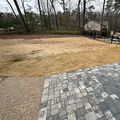 Finished drainage channel with river rock and edging detail