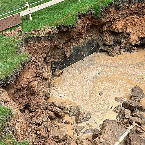 Heavy standing water exposed during the excavation process