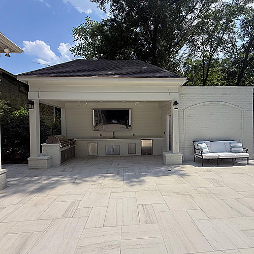 Covered outdoor kitchen beside the limestone terrace
