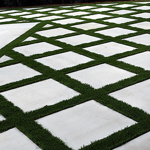 Limestone squares separated by green turf joints