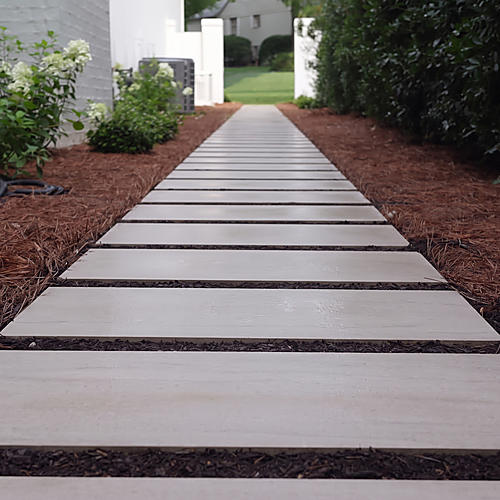 Limestone stepping-stone path between planting beds
