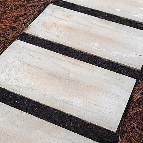 Limestone path slabs separated by dark joints