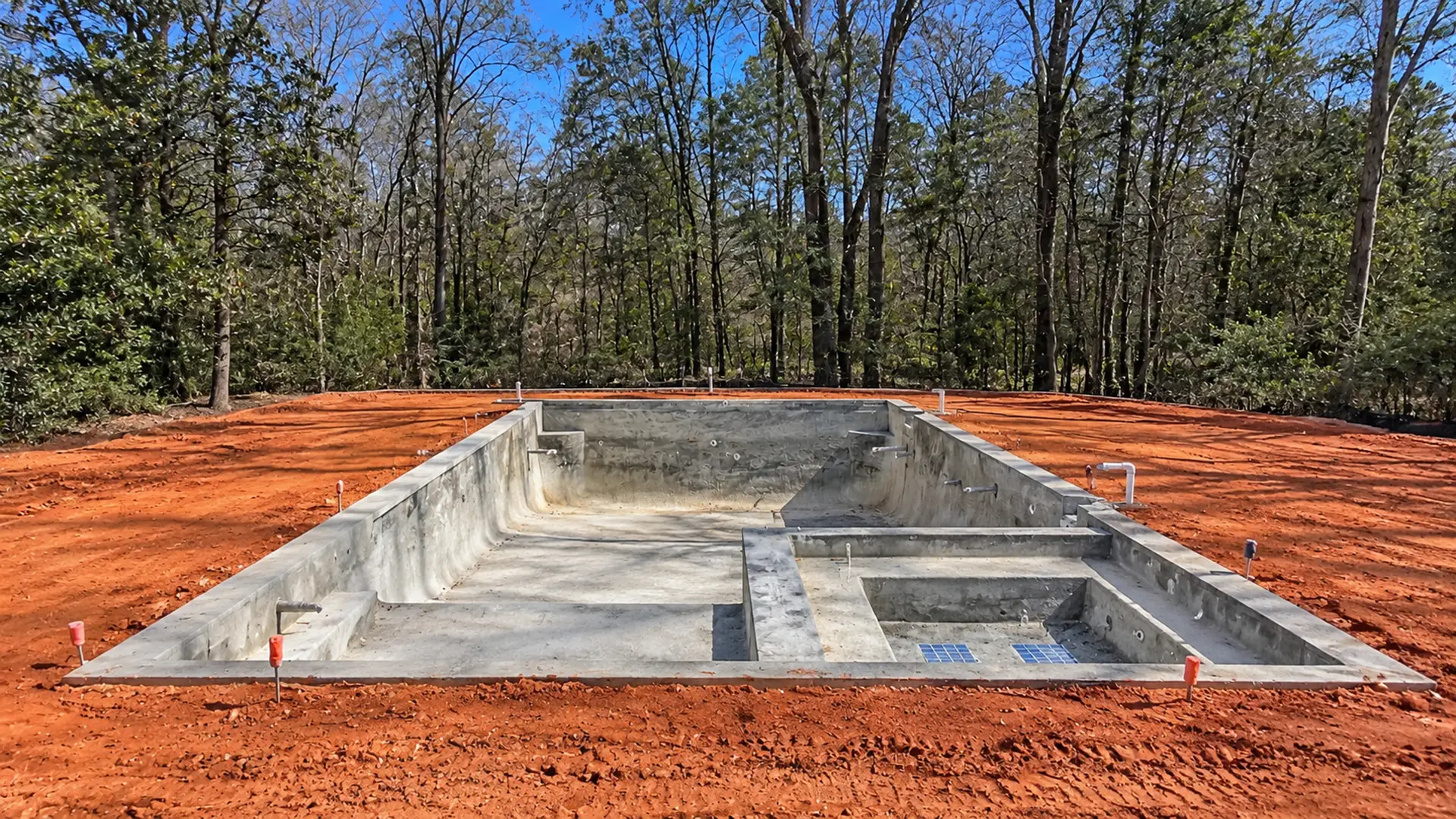 Pool shell and exposed soil before the limestone pool deck installation