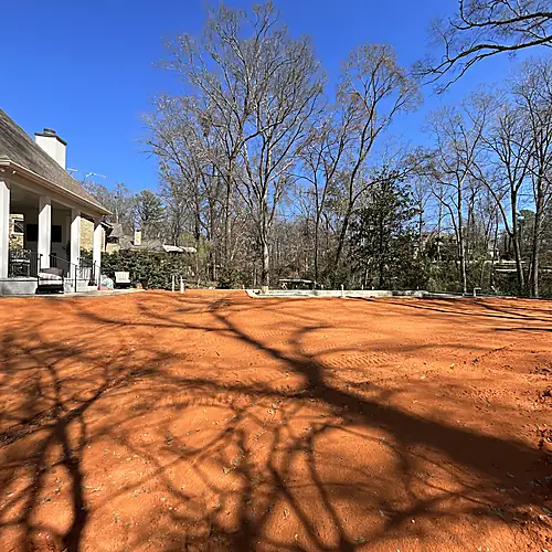 Raised backyard filled and graded beside the house