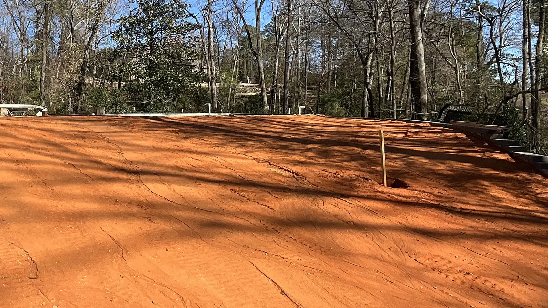 Newly filled and graded backyard after retaining wall construction