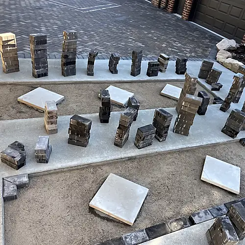 Pavers and cut pieces arranged during decorative inlay installation