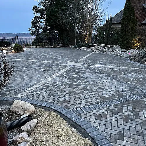 Prepared gravel base beside the curved paver driveway edge
