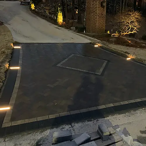 Belgard Holland Stone driveway with decorative inlays at night