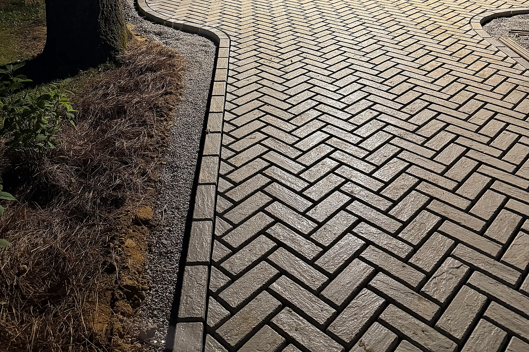 Sunlit close-up of the finished paver field and border detail
