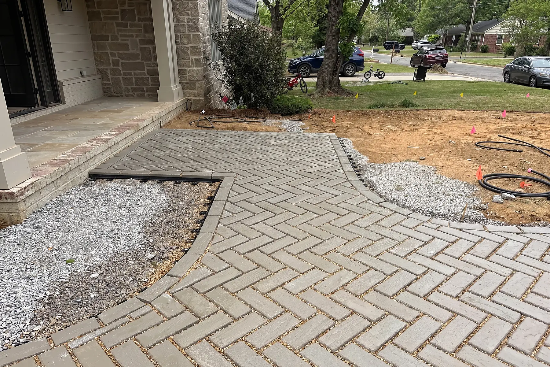 Paver installation in progress at the front porch with field pattern being set