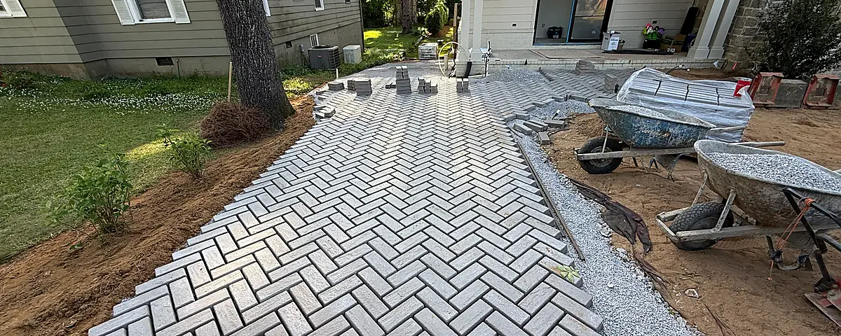Paver installation integrated with surrounding materials and outdoor space