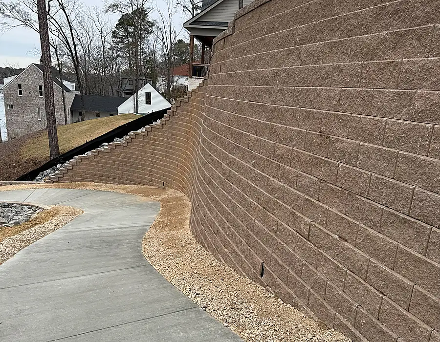 Wall edge and paving transition within a controlled site grade